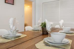 a wooden table with plates and wine glasses on it at The Tides Ocean Luxury Suites in Hollywood