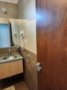 里奥夸尔托CALIDO-Departamento 1 dormitorio amueblado excelente ubicacion的带木门和水槽的浴室 更多10张照片