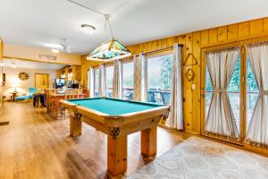 a pool table in a room with wooden walls at On The River in Estes Park