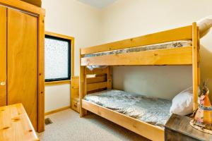 a bedroom with two bunk beds and a table at On The River in Estes Park