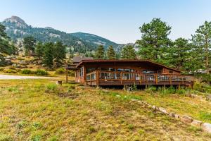 a large wooden house in the middle of a field at On The River in Estes Park