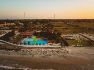 an aerial view of a swimming pool with a kite at Hotel Vila Jardim in Parajuru