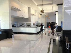 a lobby of a building with people walking in it at Piazza diRoma - Apartamentos JN in Caldas Novas