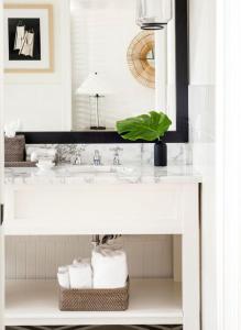 a bathroom with a sink and a white counter with towels at Inn on the Lakes in Sebring