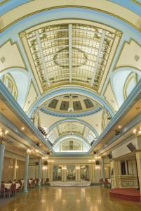 a large ballroom with a ceiling with windows at The Savoy Hotel in Blackpool