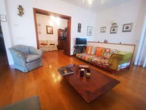 a living room with a couch and a table at Villa Liberty in Venice-Lido