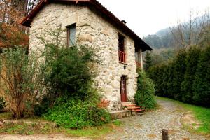 a stone house with a pathway leading to it at Casa Da Peneda in Geres