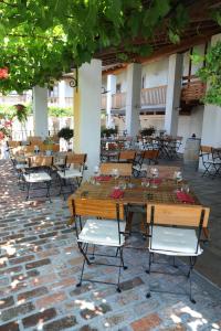 
a patio area with tables, chairs and umbrellas at Belica Bed and Breakfast in Dobrovo
