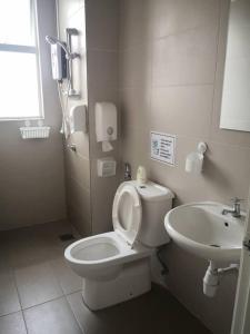 a bathroom with a toilet and a sink at My Homestay S1311 - Golden Hills Night Market in Cameron Highlands