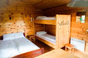 a bedroom with two bunk beds in a log cabin at Chalet in Myza Igaste