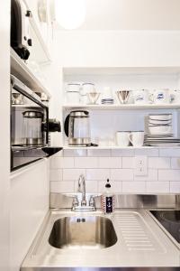 a kitchen counter with a sink in a kitchen at Nautical Nest Hudson in Hudson