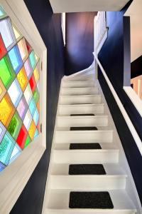 a staircase with a stained glass window at Nautical Nest Hudson in Hudson