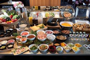 a buffet with many different types of food on a table at Jodogahama Park Hotel in Miyako