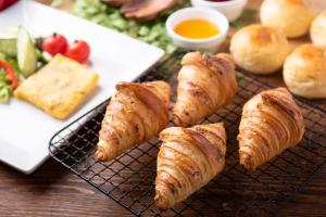 a rack of croissants and bread on a table at Jodogahama Park Hotel in Miyako