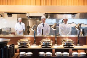 a group of chefs standing in a kitchen at Jodogahama Park Hotel in Miyako