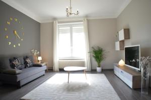 a living room with a couch and a table at Le Saint-Bernard in Metz