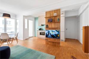 a living room with a kitchen and a dining room at Bright and stylish apartment next to the sea! in Ostend