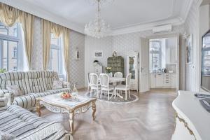 a living room with a couch and a table at Apartment Luxury Nostalgia in Karlovy Vary