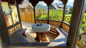 a table on the porch of a gazebo at Bianca,s Ferienwohnung in Bad Mitterndorf