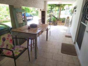 a kitchen with a table and chairs in a room at Cozy stone house in Sikéa