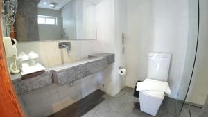 a bathroom with a toilet and a sink and a mirror at Bopha Bassac Boutique Hotel in Phnom Penh