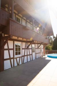 a house with a balcony and a swimming pool at Haus Nilson in Gengenbach