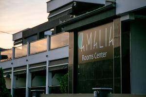 um edifício com um sinal na lateral em Amalia Center em Nea Vrasna