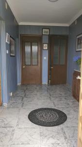 a lobby with three doors and a rug on the floor at Casa do Gaiteiro - Casa de Aldea en O Pereiro in Pereiro