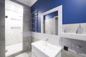 a bathroom with a sink and a mirror at Lviv4U in Lviv +85 photos