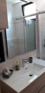 a bathroom with a sink and a mirror and a sink at Cabà Holiday Bardolino Colombo in Bardolino