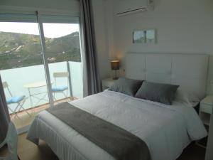 a bedroom with a bed and a large window at Villa Esperanza - Canillas de Albaida in Canillas de Albaida +42 photos