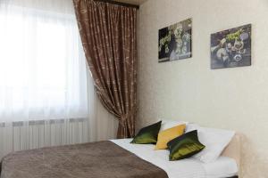 a bedroom with a bed with three pictures on the wall at Central Apartament near by Marriott hotel in Novosibirsk