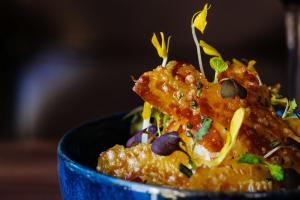 a blue bowl filled with food on a table at Kimpton - Hotel Arras, an IHG Hotel in Asheville