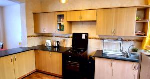 A kitchen or kitchenette at Little Green Room Homestay near JKIA Airport & SGR Railway Station