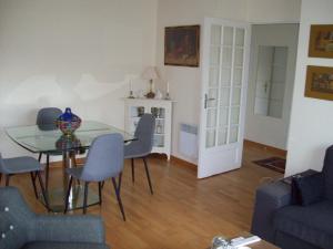 - un salon avec une table et des chaises en verre dans l'établissement T2 avec box proche Graslin, à Nantes