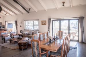 a dining room with a wooden table and chairs at Rhino Retreat Clarens in Clarens