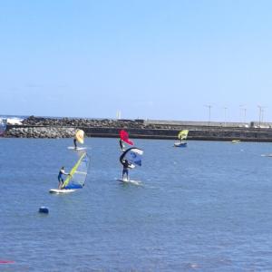 a group of people on surfboards in the water at La Villa Des Lys in Saint-Pierre