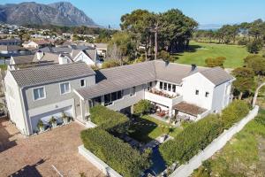 an aerial view of a large white house at Hermanus Lodge on the Green - Solar Power in Hermanus