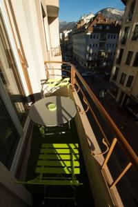 a balcony with a table and chairs on a building at Pretty 3 rooms in the city center in Annecy