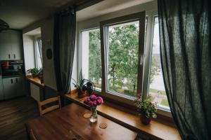 a living room with a table and a large window at City center Appartment in Valmiera