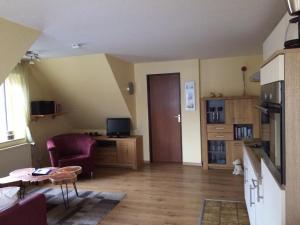 a living room with a couch and a table at Haus Achterum in Langeoog