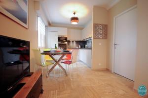 a kitchen with a table and chairs in a room at Annecy Lake - Le Saint Bernard - 2 min walk from the lake in Annecy