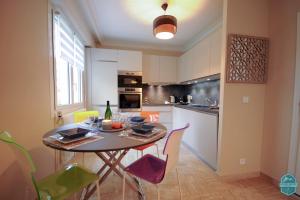 a kitchen with a table and chairs in a room at Annecy Lake - Le Saint Bernard - 2 min walk from the lake in Annecy