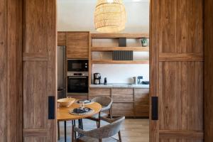 a kitchen with a wooden door and a table and chairs at Anastasia Grand Villa in Kattavía