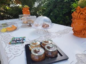 a table with several jars of food on it at Terre Di Vendicari in Noto