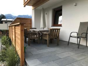 a patio with a table and chairs and a umbrella at Apartment Nagiller in Rinn