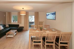a living room with a table and chairs and a couch at Relaxappartement Wymbs in Zell am See