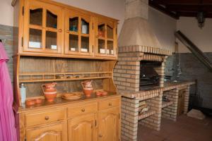 a kitchen with a stove and a brick oven at ZiZis Place in Santa Cruz