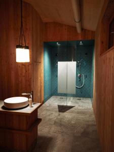 a bathroom with a shower and a sink and a tub at Hotel Neusacherhof in Weissensee +107 photos