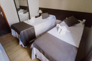 מיטה או מיטות בחדר ב-Alzira Granada Hotel